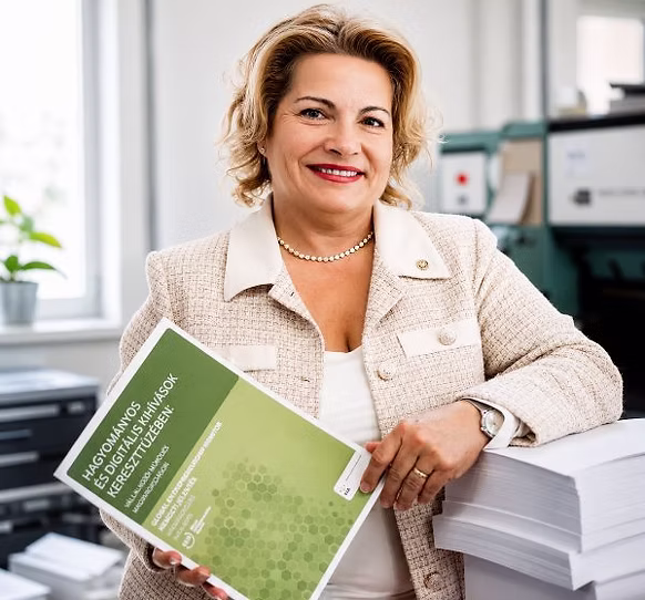 Molnár Júlia egy frissen nyomtatott kiadvánnyal a nyomdában